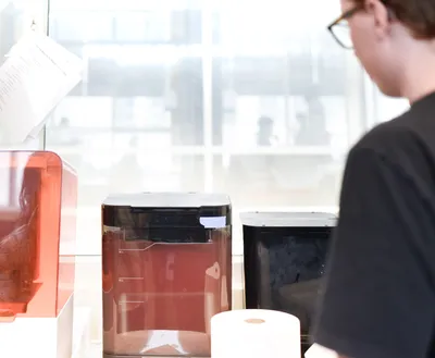 Ethan washing resin prints in the BIDC lab.